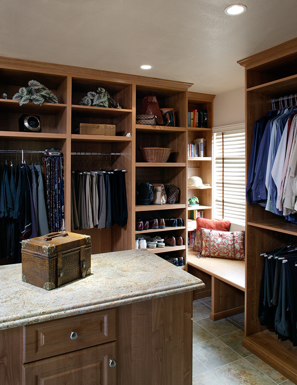 Mid-sized mediterranean men's dressing room in Los Angeles with raised-panel cabinets and medium wood cabinets.