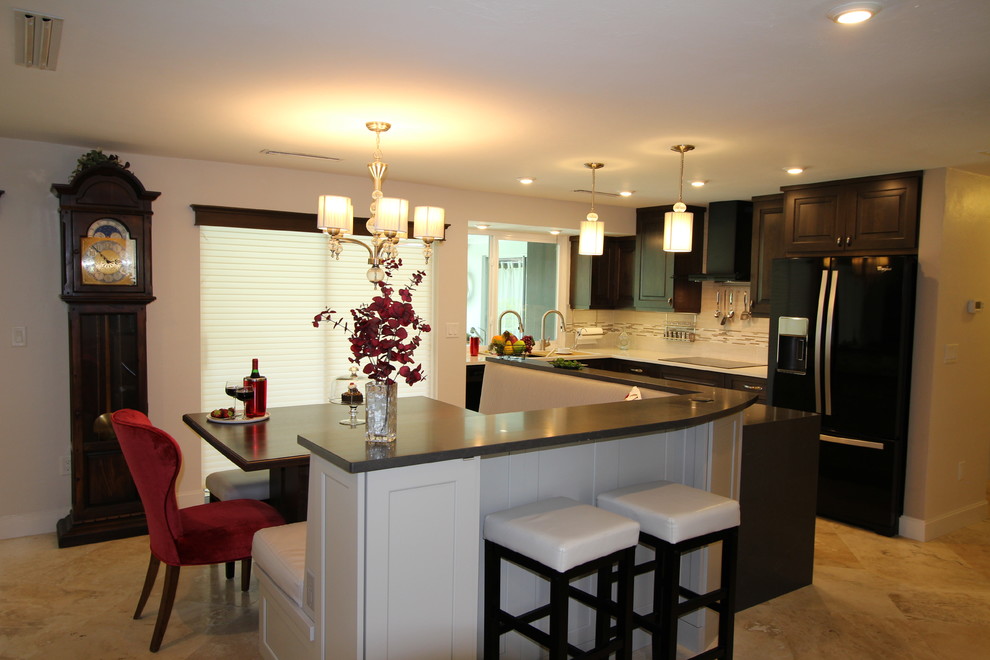 Transitional l-shaped eat-in kitchen photo in Miami with an undermount sink, flat-panel cabinets, gray cabinets, quartzite countertops, white backsplash, subway tile backsplash, black appliances and an island