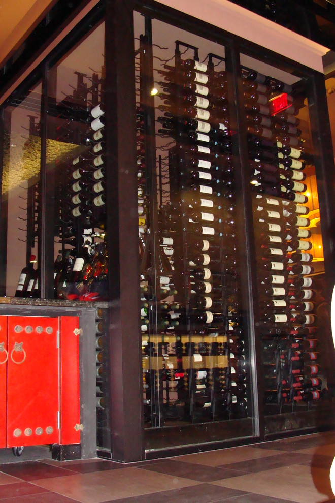 This is an example of a mid-sized modern wine cellar in Orange County with display racks.