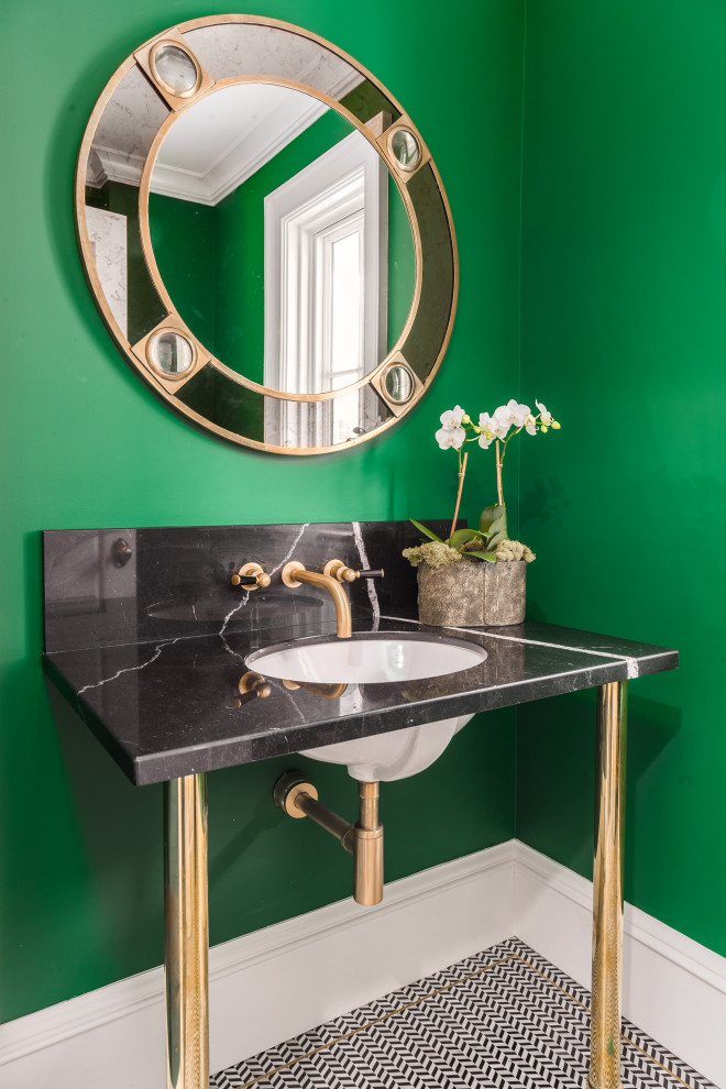 Inspiration for a transitional multicolored floor powder room remodel in New York with green walls, a console sink and black countertops