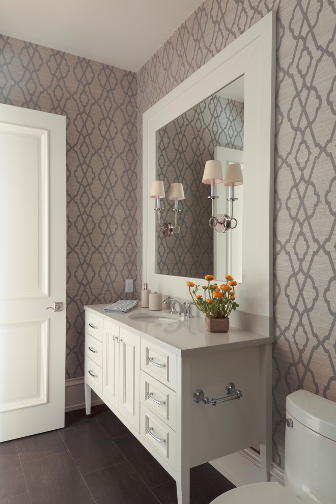 Inspiration for a large transitional powder room in Miami with an undermount sink, recessed-panel cabinets, white cabinets, granite benchtops, a one-piece toilet, brown tile, grey walls and dark hardwood floors.