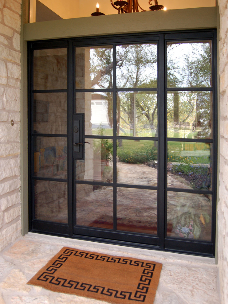 This is an example of a transitional front door in Austin with a single front door and a metal front door.