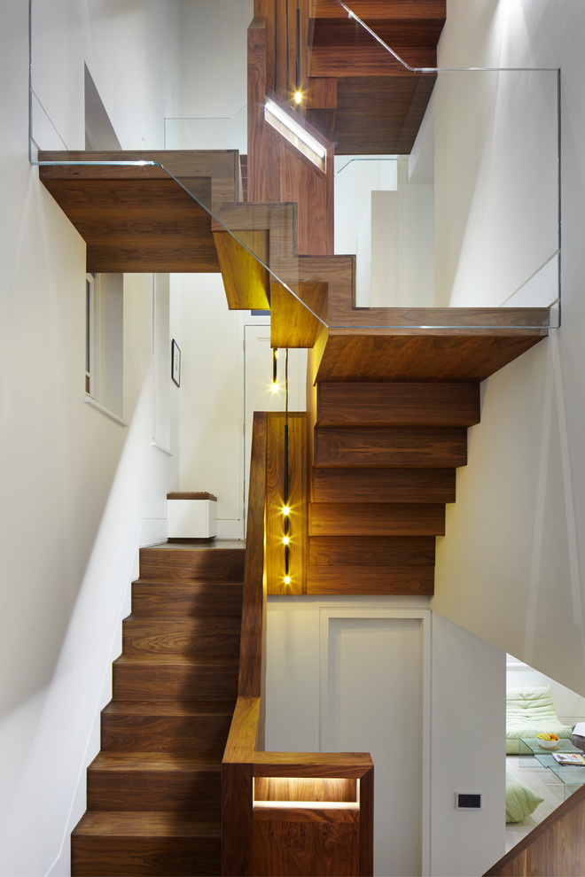 Contemporary wood u-shaped staircase in London with wood risers.