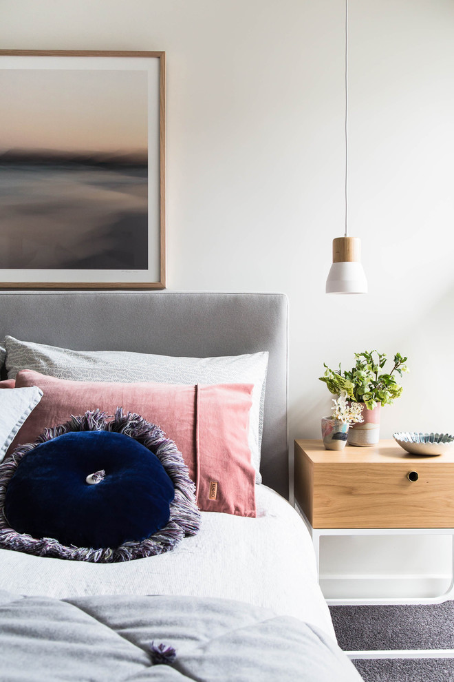 This is an example of a scandinavian master bedroom in Melbourne with white walls, carpet and grey floor.
