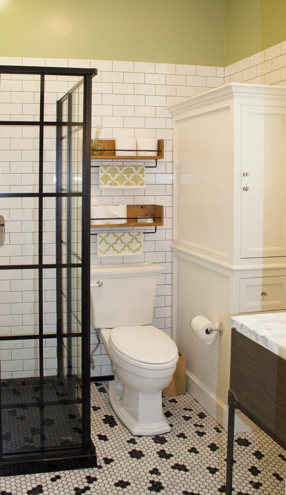Photo of a small country master bathroom in San Francisco with furniture-like cabinets, brown cabinets, an alcove shower, a two-piece toilet, white tile, ceramic tile, green walls, marble floors, an undermount sink, marble benchtops, white floor and a sliding shower screen.