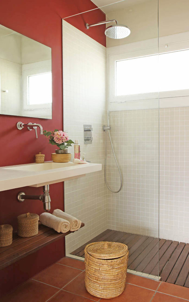 Design ideas for a mediterranean 3/4 bathroom in Other with open cabinets, an open shower, red walls, an integrated sink, orange floor, an open shower, white benchtops and beige tile.