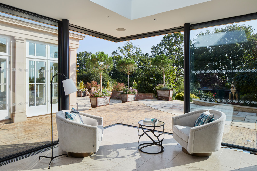 Large conservatory in Other with limestone flooring, a glass ceiling and beige floors.