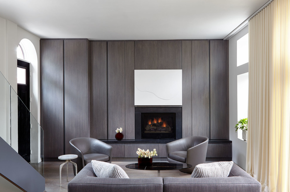 This is an example of a mid-sized modern open concept living room in New York with white walls, a standard fireplace, a stone fireplace surround, a concealed tv, brown floor and dark hardwood floors.