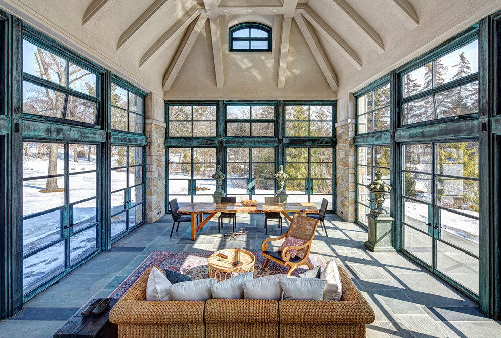 This is an example of a large traditional sunroom in Detroit with a standard ceiling, grey floor and slate floors.