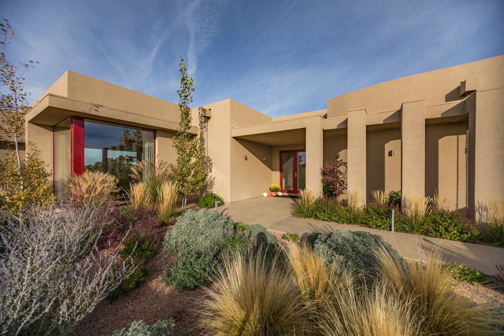 Design ideas for a large contemporary courtyard partial sun xeriscape in Albuquerque with a garden path.