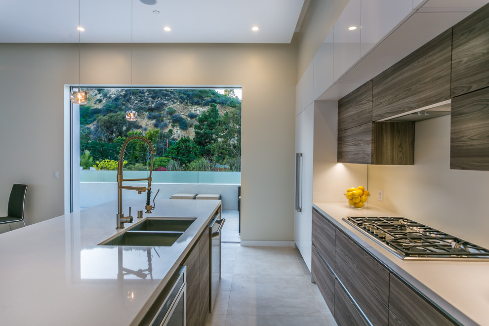 Photo of a modern eat-in kitchen in Los Angeles with a double-bowl sink, open cabinets, white cabinets, quartz benchtops, white splashback, stainless steel appliances, porcelain floors and with island.