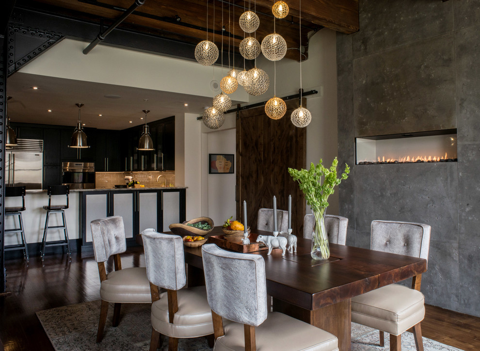 Industrial kitchen/dining combo in Philadelphia with white walls, a concrete fireplace surround and a ribbon fireplace.