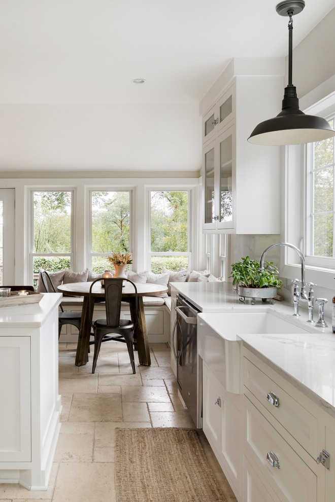 Inspiration for a large country l-shaped separate kitchen in Minneapolis with a farmhouse sink, shaker cabinets, white cabinets, marble benchtops, grey splashback, stone slab splashback, stainless steel appliances, travertine floors, with island and beige floor.