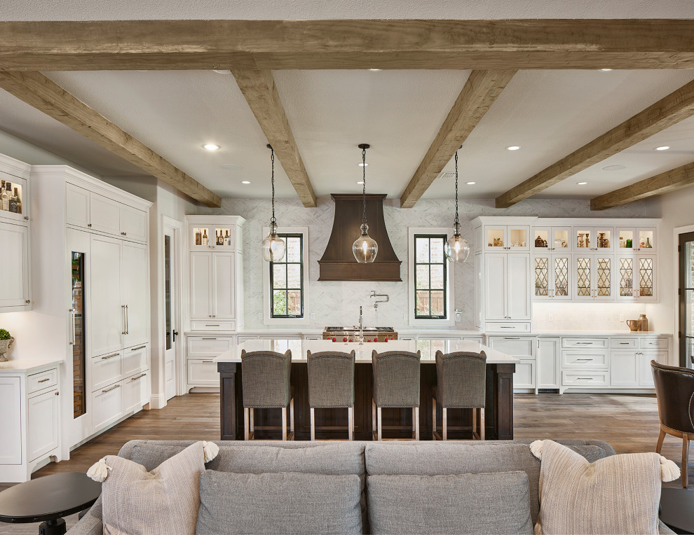 Inspiration for a traditional l-shaped kitchen in Dallas with shaker cabinets, grey cabinets, quartz benchtops, light hardwood floors and with island.