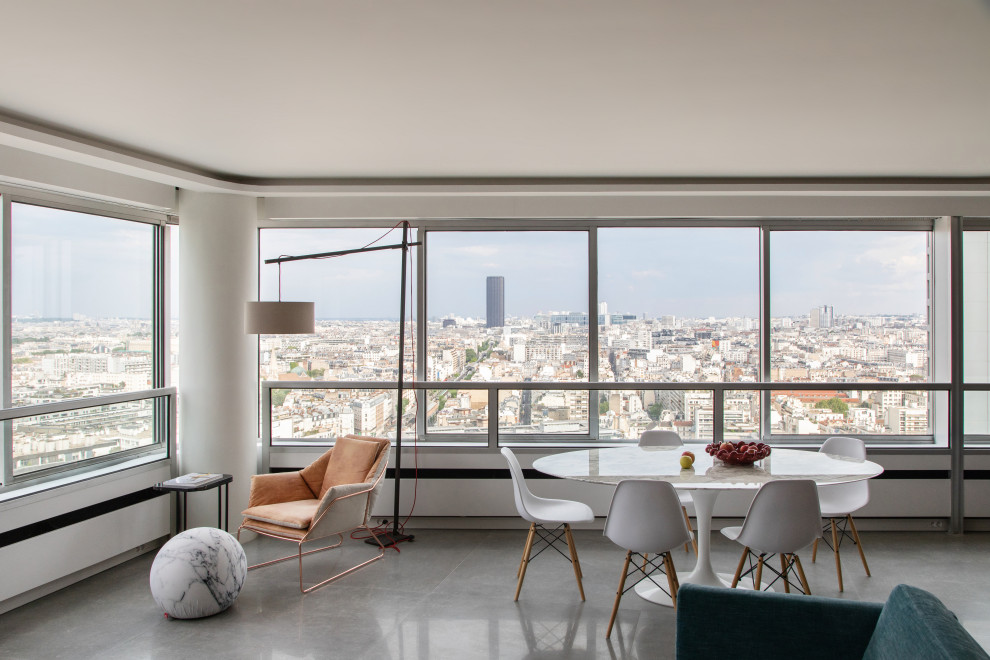 Photo of a large contemporary open plan dining in Paris with white walls, ceramic floors, grey floor and recessed.