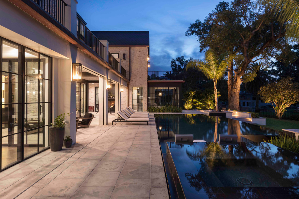 Example of a huge transitional backyard ground level deck design in Orlando with no cover