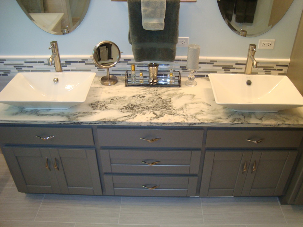 Large beach style master bathroom in Chicago with a vessel sink, shaker cabinets, grey cabinets, marble benchtops, a freestanding tub, an open shower, a two-piece toilet, gray tile, porcelain tile, blue walls and porcelain floors.