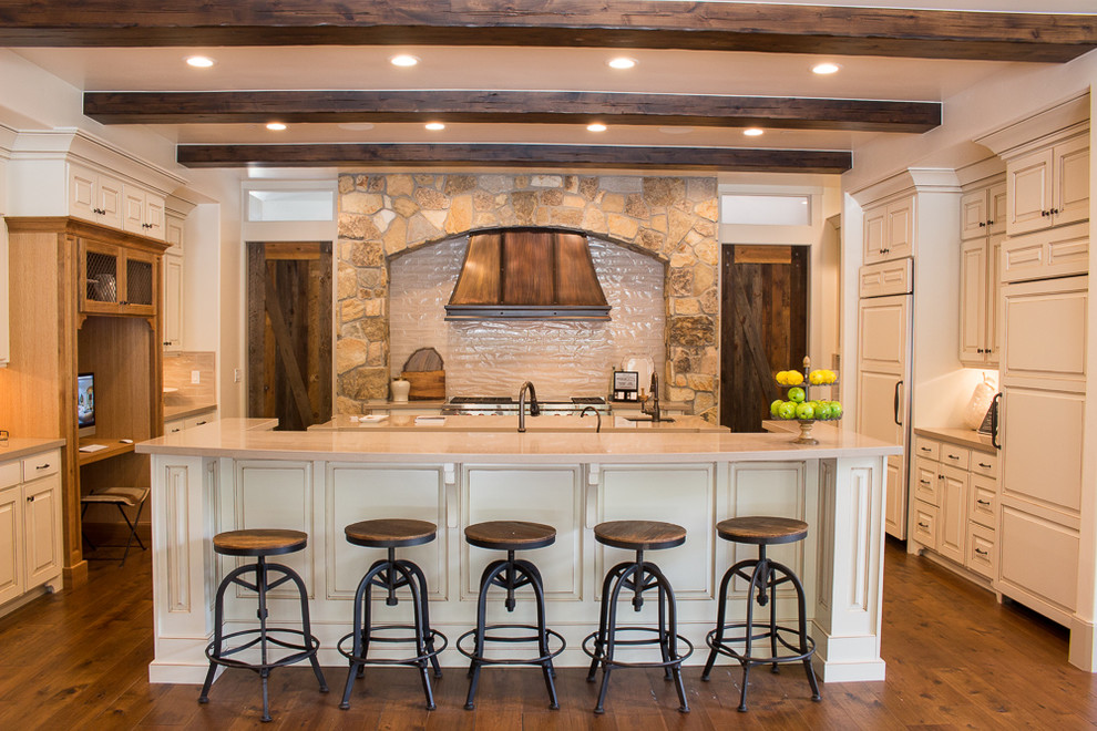 Inspiration for a large arts and crafts galley open plan kitchen in Salt Lake City with a farmhouse sink, raised-panel cabinets, distressed cabinets, quartz benchtops, beige splashback, ceramic splashback, stainless steel appliances, dark hardwood floors and multiple islands.