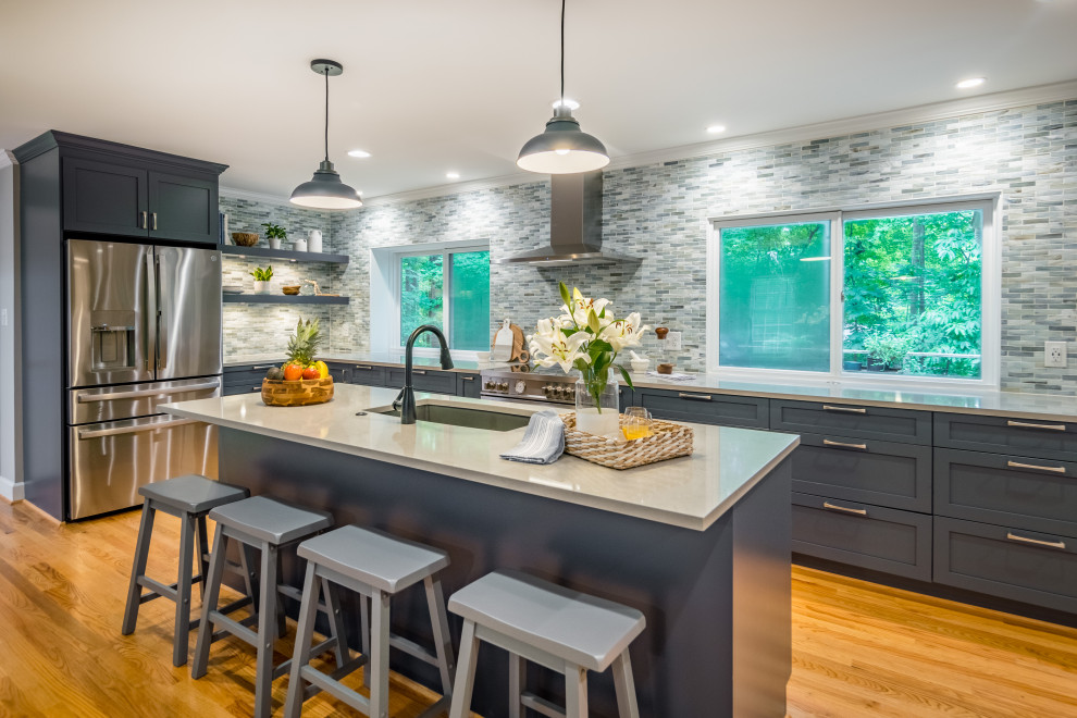 Example of a mid-sized transitional eat-in kitchen design in Raleigh with gray backsplash, stainless steel appliances, an undermount sink and an island