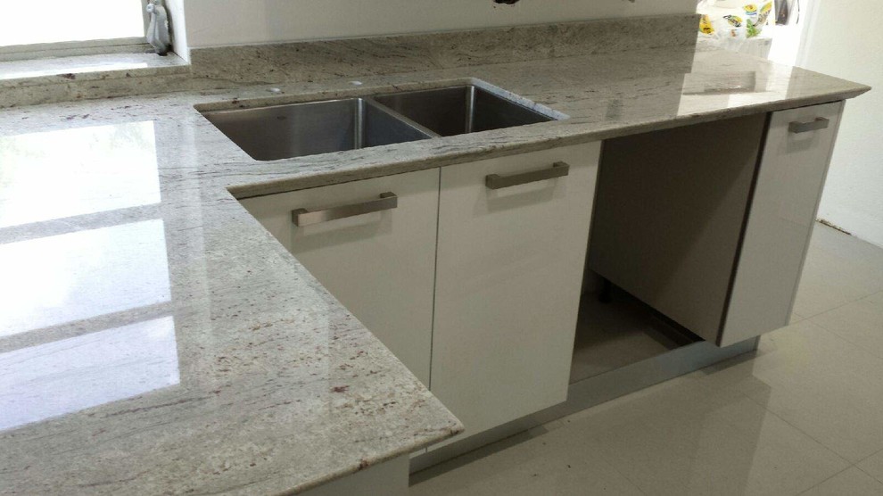 Eat-in kitchen - modern eat-in kitchen idea in Miami with a double-bowl sink, flat-panel cabinets, white cabinets and gray backsplash