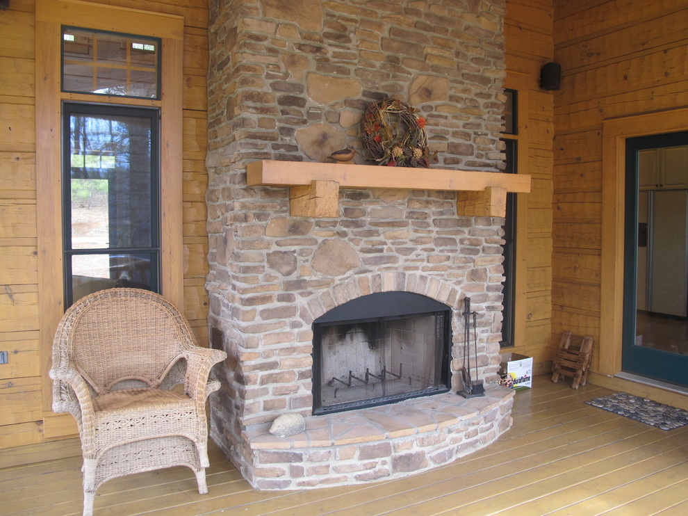 Deck - mid-sized rustic backyard deck idea in Detroit with a fire pit and a roof extension