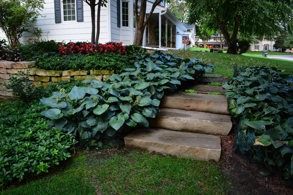Inspiration for a mid-sized traditional backyard shaded garden in Omaha with natural stone pavers.