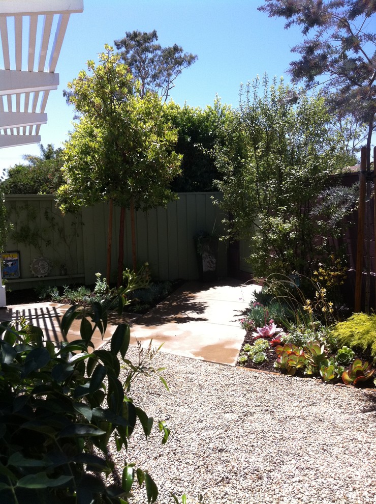 This is an example of a mid-sized contemporary backyard partial sun xeriscape in Orange County with a vertical garden and concrete pavers.
