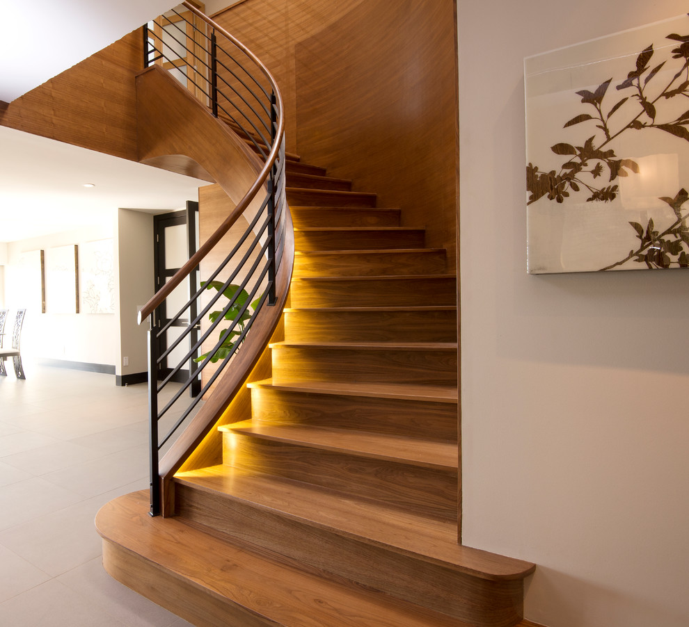 Design ideas for a mid-sized contemporary wood curved staircase in Orange County with wood risers.