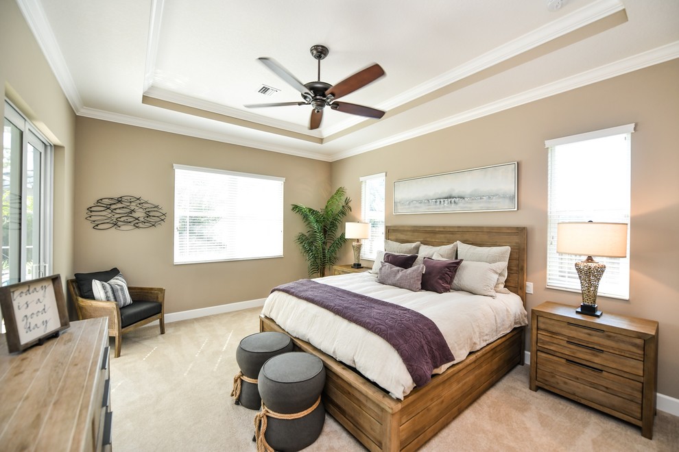 Beach style bedroom in Tampa with beige walls, carpet and beige floor.