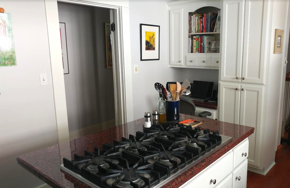Mid-sized transitional l-shaped dark wood floor and brown floor enclosed kitchen photo in Charlotte with a double-bowl sink, shaker cabinets, white cabinets, granite countertops, stainless steel appliances and an island