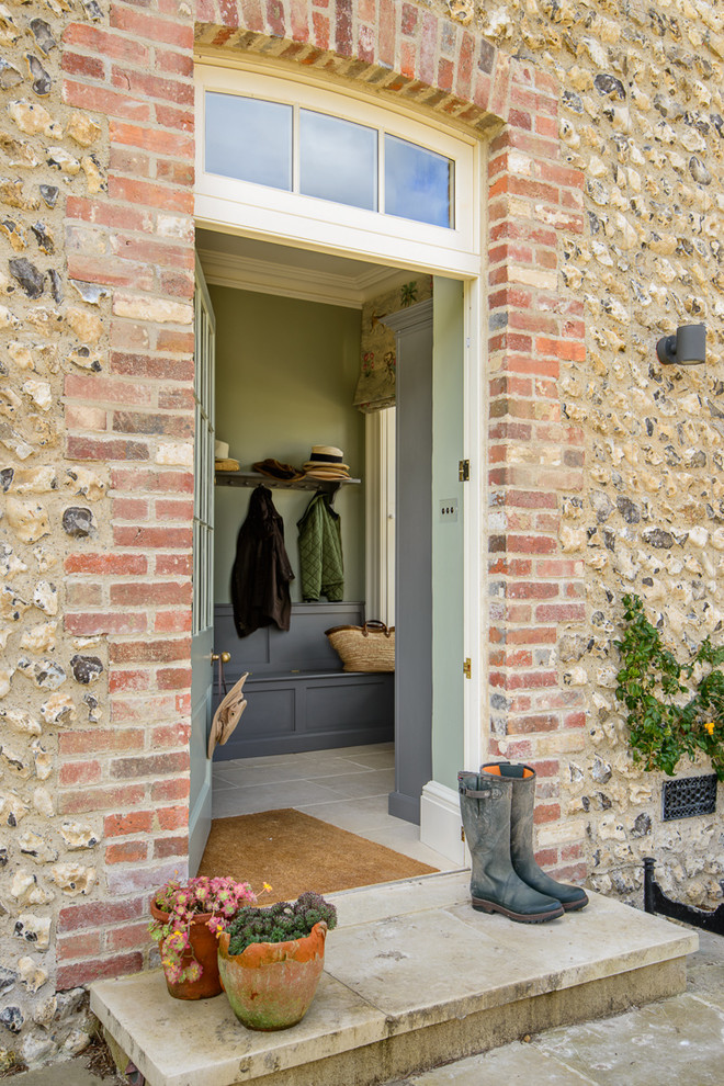 This is an example of a country front door in Other with green walls, a single front door and a gray front door.