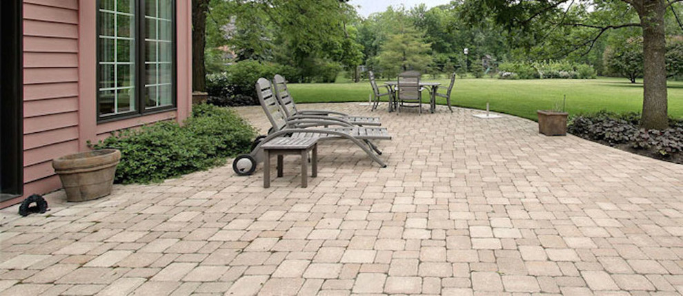 Large backyard brick patio photo with no cover