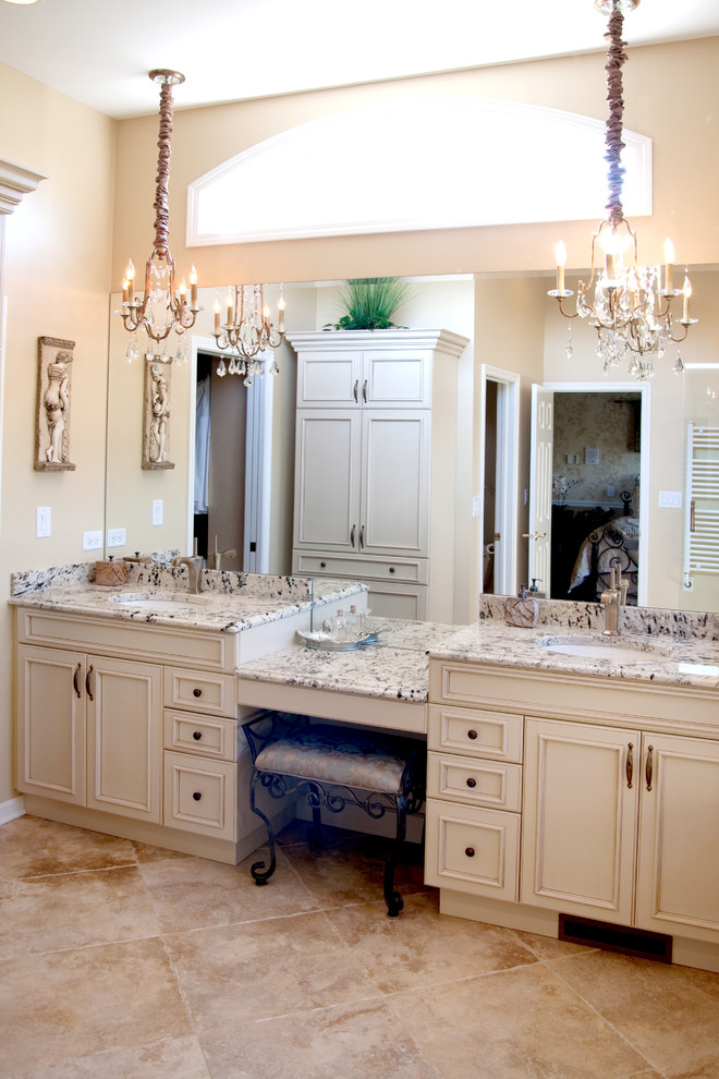 Design ideas for a large traditional master bathroom in Chicago with recessed-panel cabinets, white cabinets, a one-piece toilet, beige walls, travertine floors, an undermount sink and granite benchtops.