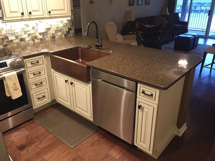 Eat-in kitchen - small transitional u-shaped dark wood floor and brown floor eat-in kitchen idea in St Louis with a farmhouse sink, raised-panel cabinets, white cabinets, granite countertops, multicolored backsplash, glass tile backsplash, stainless steel appliances and an island