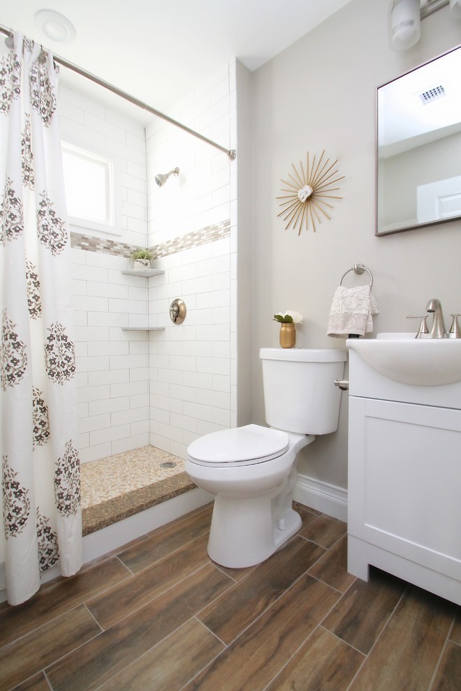 Inspiration for a small transitional 3/4 bathroom in Boston with shaker cabinets, white cabinets, an alcove shower, a one-piece toilet, white tile, ceramic tile, grey walls, vinyl floors, a vessel sink, engineered quartz benchtops, brown floor, a shower curtain and white benchtops.