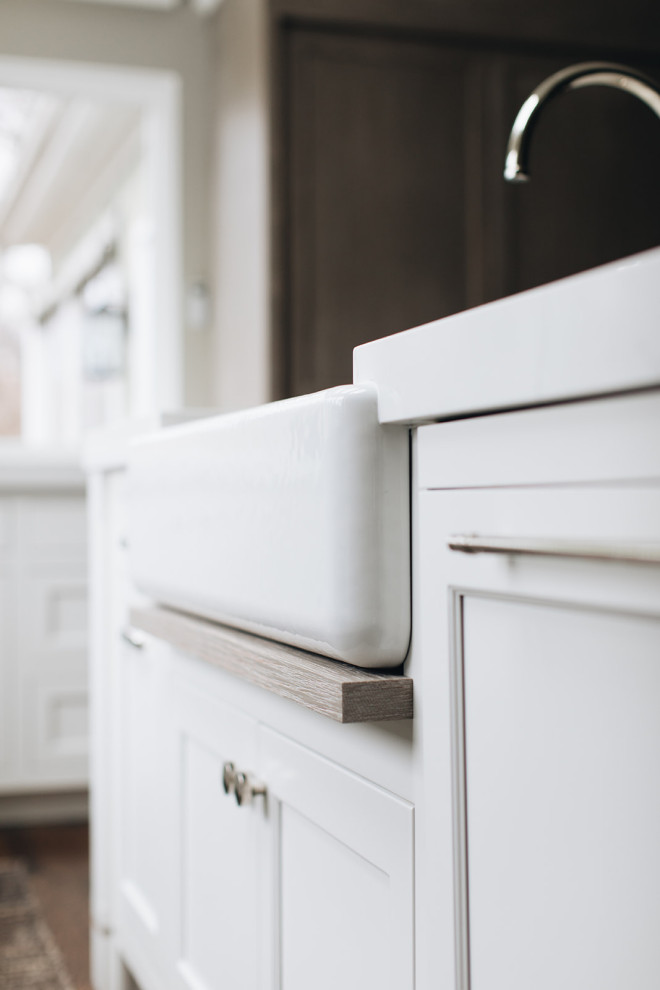 Mid-sized transitional dark wood floor and brown floor eat-in kitchen photo in Chicago with a farmhouse sink, beaded inset cabinets, white cabinets, quartz countertops, paneled appliances, an island and white countertops