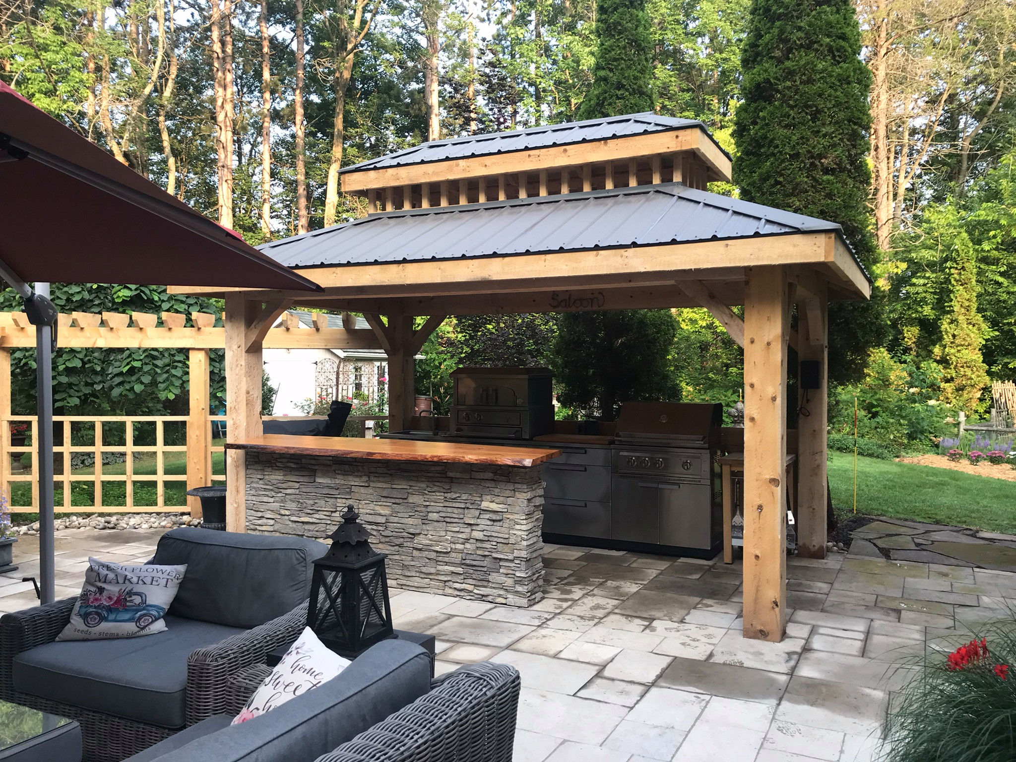 Outdoor living in a practical way. The small footprint of this cabana with its fully functioning kitchen makes it the definition of clever. Sporting a pizza oven, grill, smoker, and sink, you can prep
