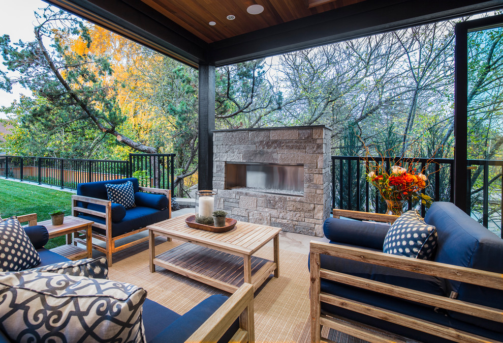 Design ideas for a transitional patio in Seattle with a roof extension and with fireplace.