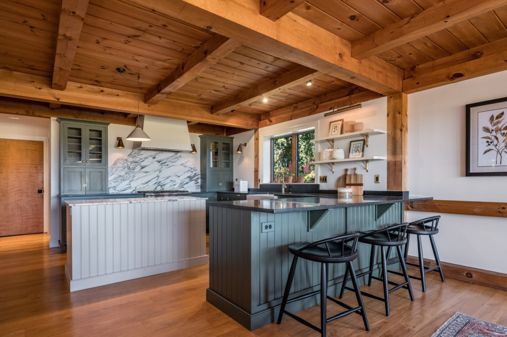 Inspiration for a mid-sized rustic u-shaped medium tone wood floor, brown floor and wood ceiling eat-in kitchen remodel in Boston with a farmhouse sink, recessed-panel cabinets, green cabinets, granite countertops, white backsplash, marble backsplash, stainless steel appliances, two islands and black countertops