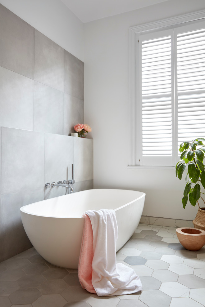 Inspiration for a large contemporary master bathroom in Melbourne with a freestanding tub, white walls, flat-panel cabinets, light wood cabinets, an open shower, gray tile, white tile, mosaic tile, mosaic tile floors, a vessel sink and solid surface benchtops.
