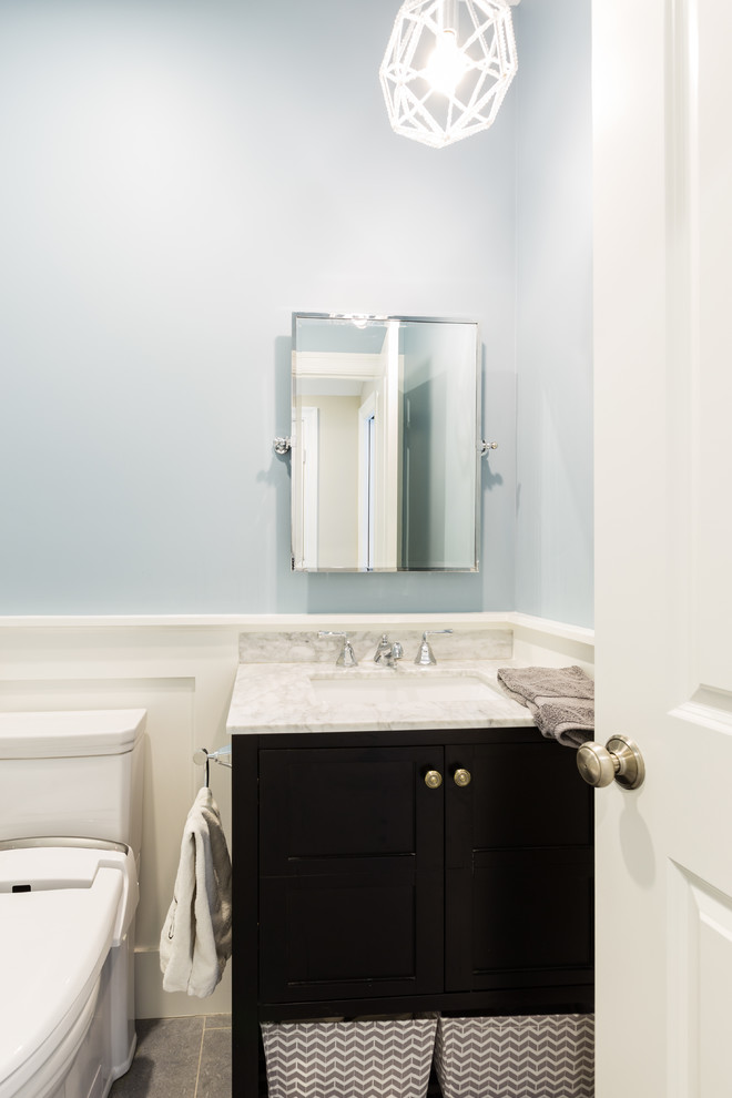 Inspiration for a small transitional powder room in Boston with beaded inset cabinets, grey cabinets, a bidet, gray tile, ceramic tile, blue walls, ceramic floors, an undermount sink and engineered quartz benchtops.