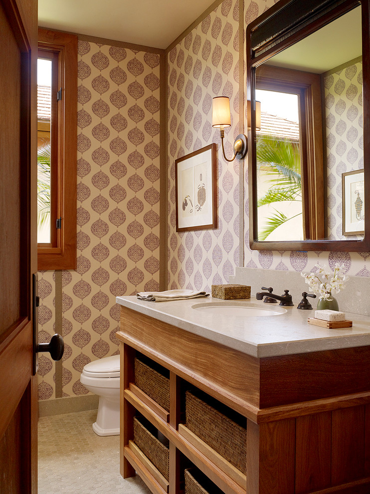 Design ideas for a tropical powder room in Hawaii with an undermount sink, open cabinets, medium wood cabinets and beige tile.