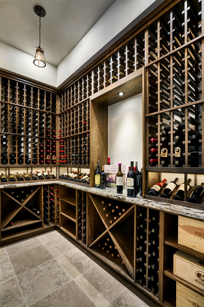 Design ideas for a mid-sized country wine cellar in Portland with travertine floors, storage racks and beige floor.
