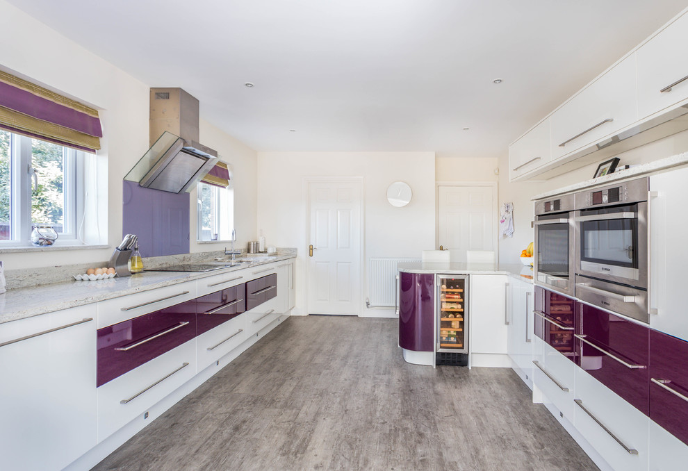 This is an example of a contemporary kitchen in Other with flat-panel cabinets, purple cabinets, glass sheet splashback, stainless steel appliances, no island, grey floor and beige benchtop.