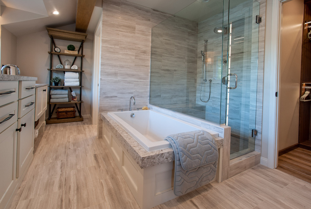 Large transitional master bathroom in Los Angeles with shaker cabinets, white cabinets, an open shower, a one-piece toilet, gray tile, stone tile, beige walls, limestone floors, an undermount sink and engineered quartz benchtops.