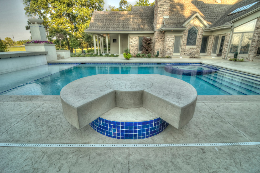 Large transitional backyard concrete paver and rectangular natural hot tub photo in Cedar Rapids