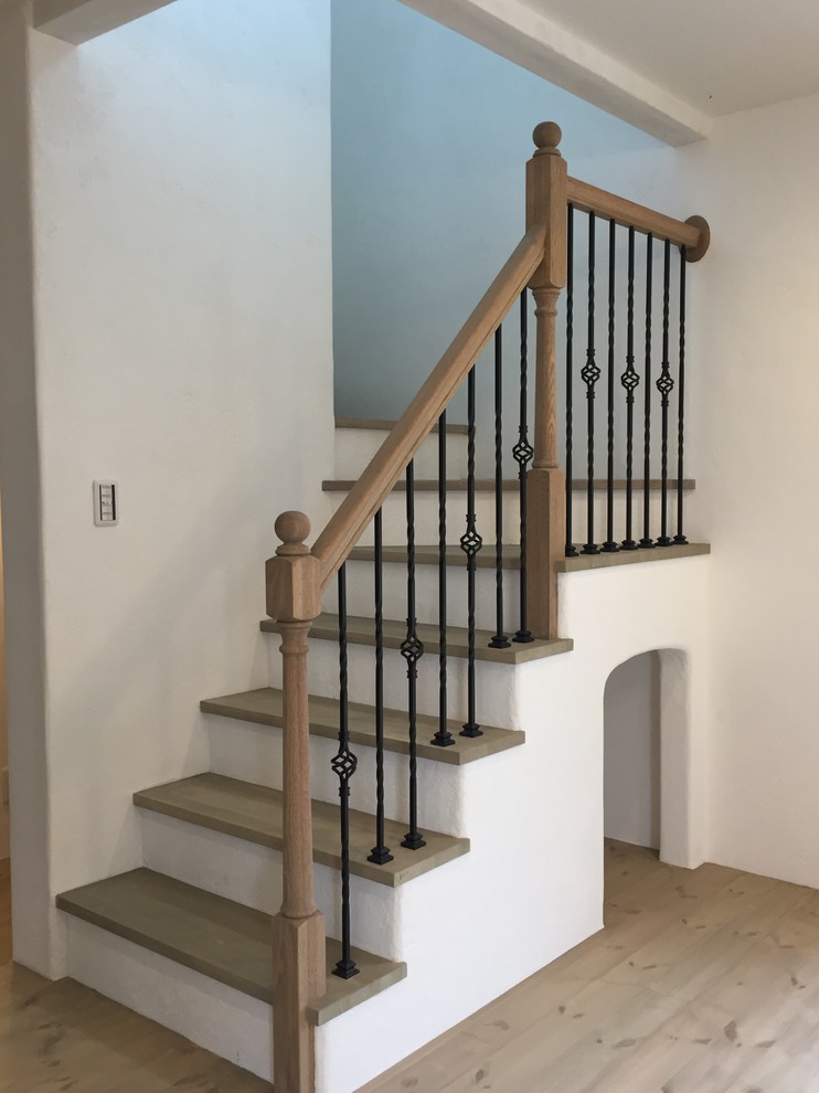 Photo of a scandinavian u-shaped staircase in Other with wood railing.