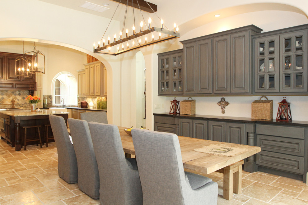 Photo of a large mediterranean kitchen/dining combo in Houston with white walls, ceramic floors and no fireplace.