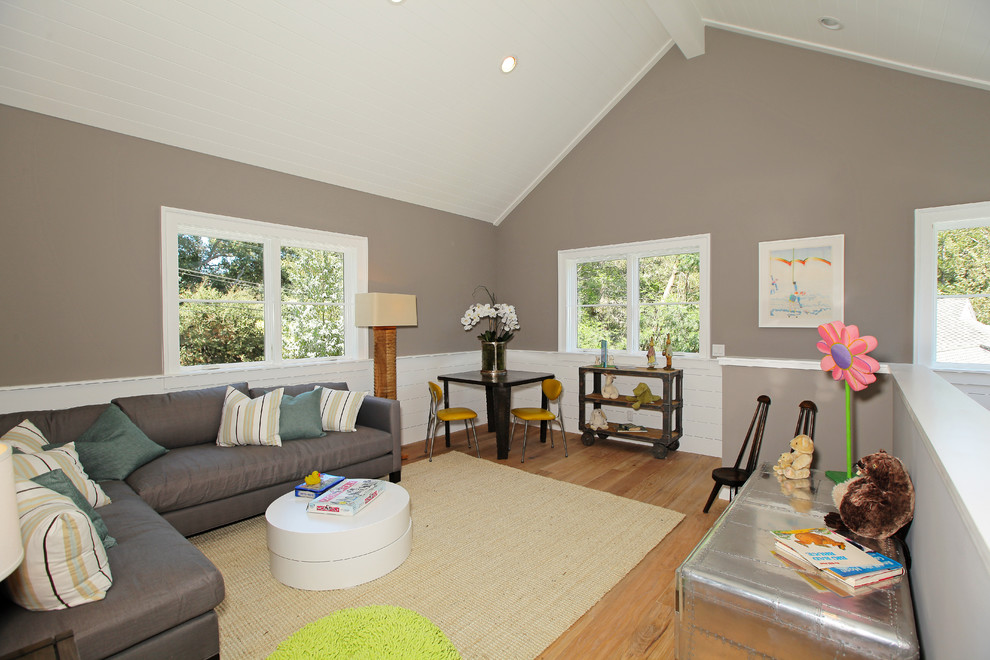 Design ideas for a transitional family room in Los Angeles with grey walls and light hardwood floors.