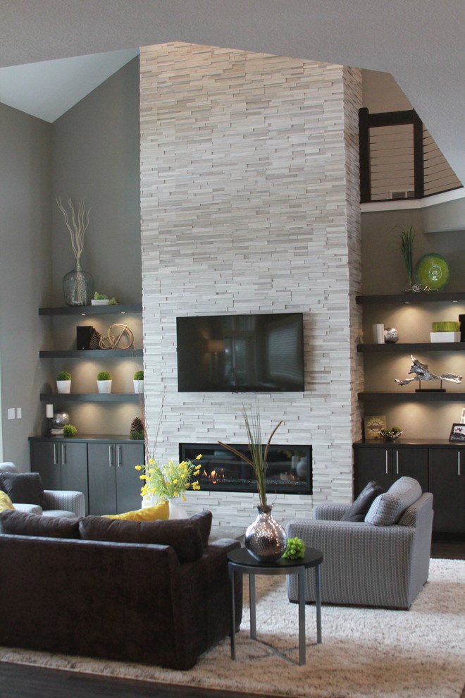Mid-sized trendy formal and open concept dark wood floor and brown floor living room photo in Milwaukee with gray walls, a ribbon fireplace, a stone fireplace and a wall-mounted tv
